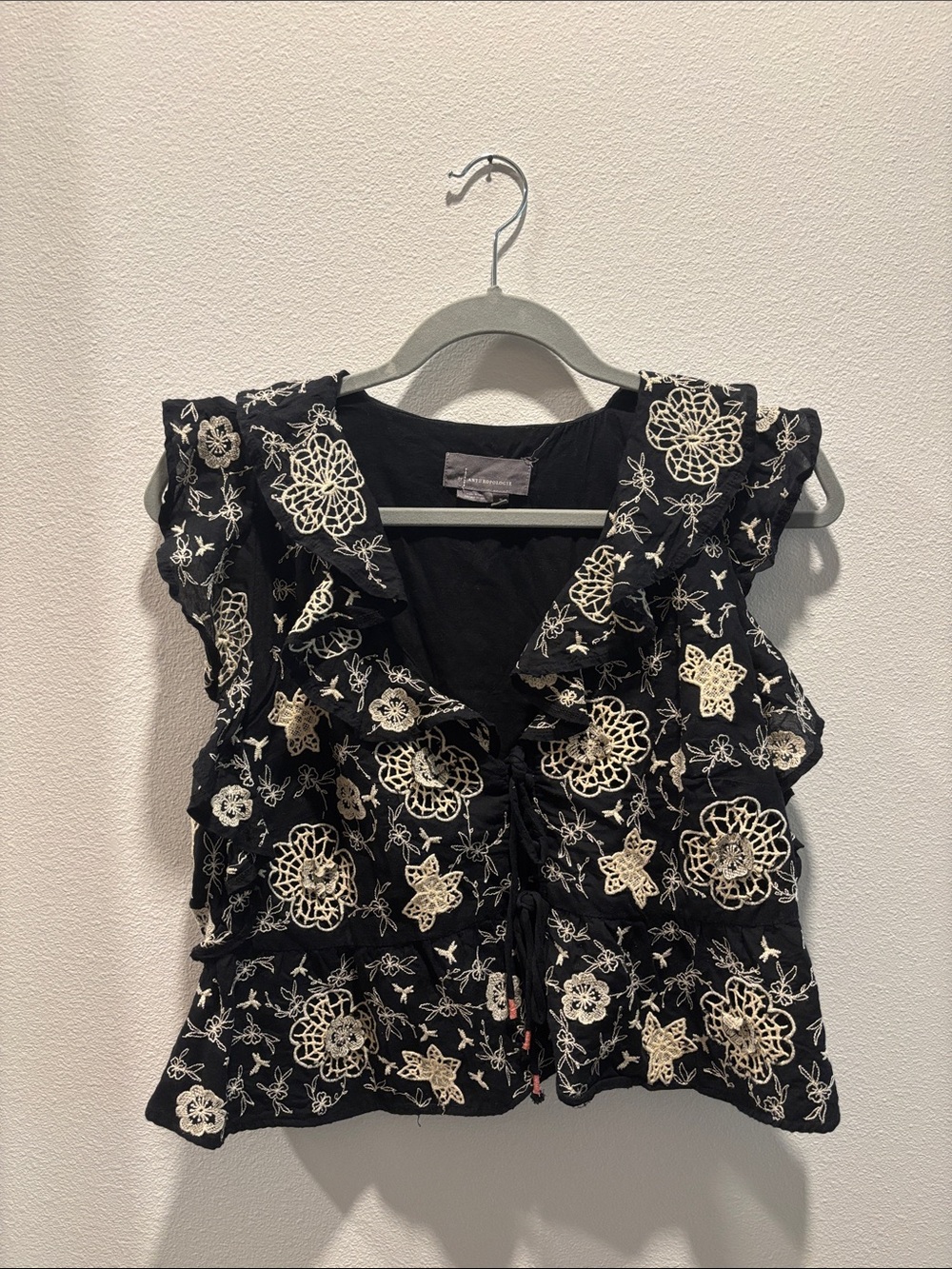 Anthropologie Black Sleeveless Ruffle Tie-Front Top with Cream Floral Embroidery